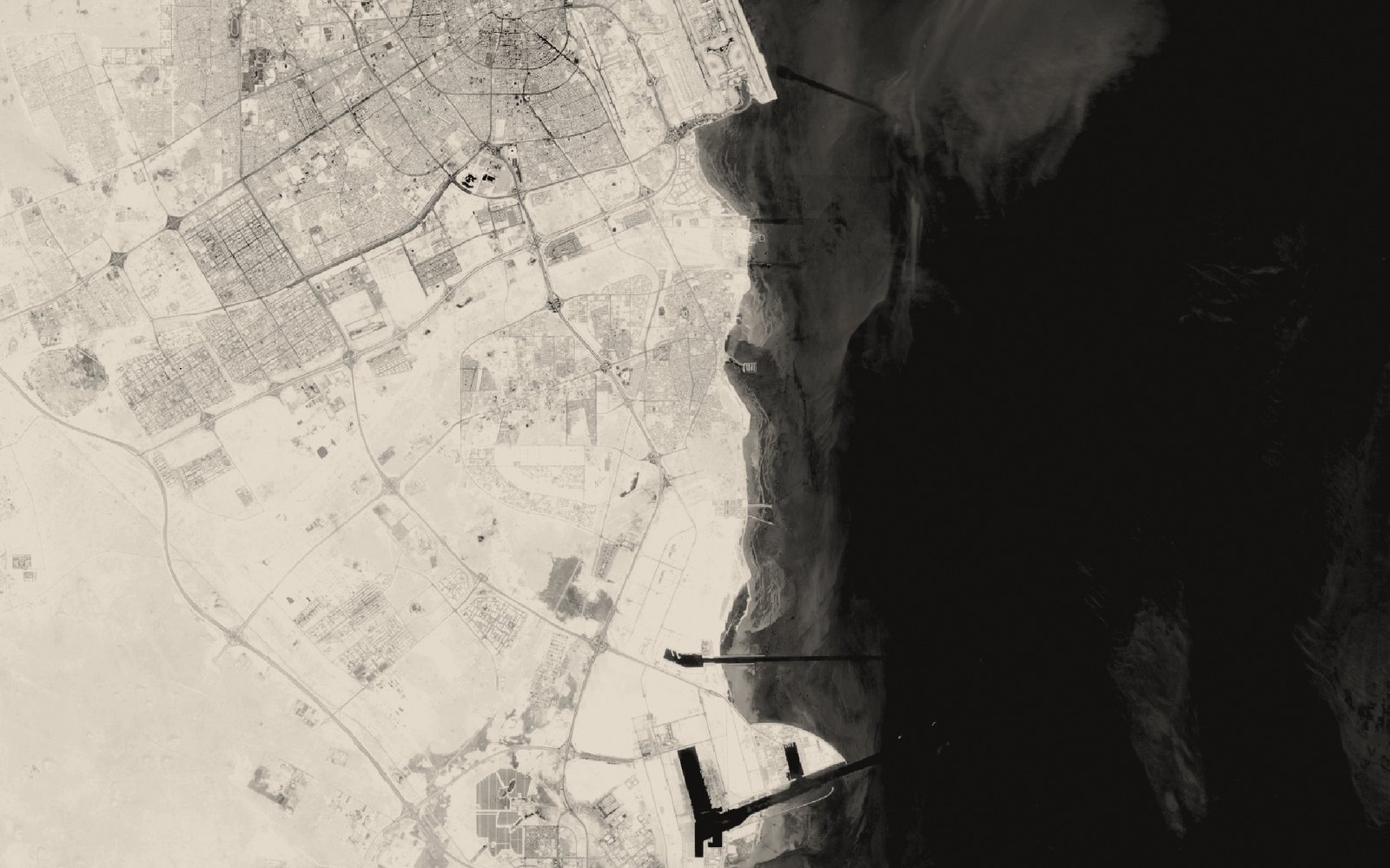 Satellite view of Gulf harbours on the Qatari coast, port breakwaters and a deep-water channel