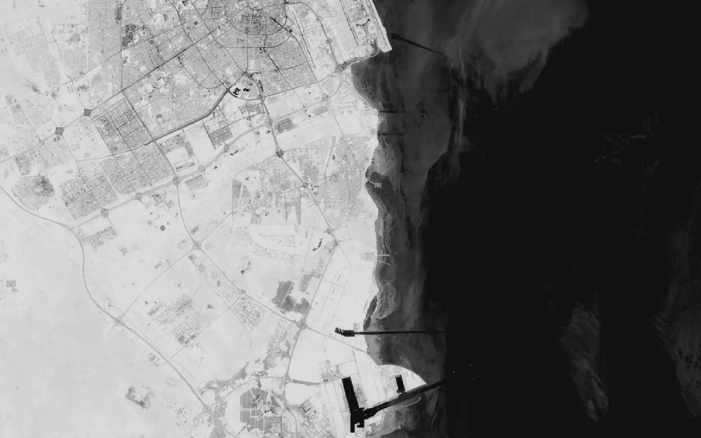 Satellite view of Gulf harbours on the Qatari coast, port breakwaters and a deep-water channel