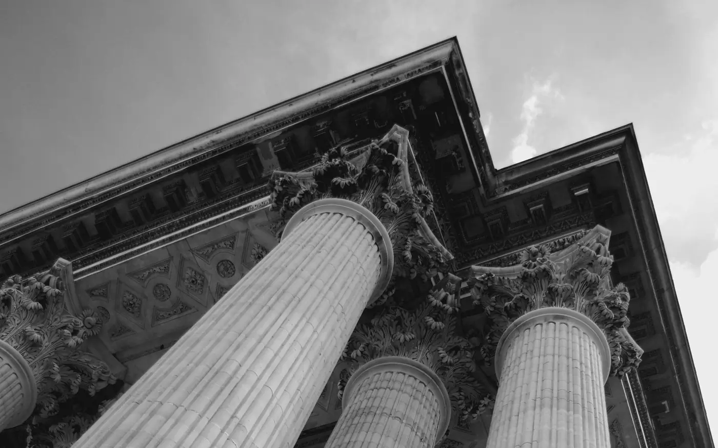 Fluted Corinthian columns of the Panthéon de Paris, viewed from below against the sky